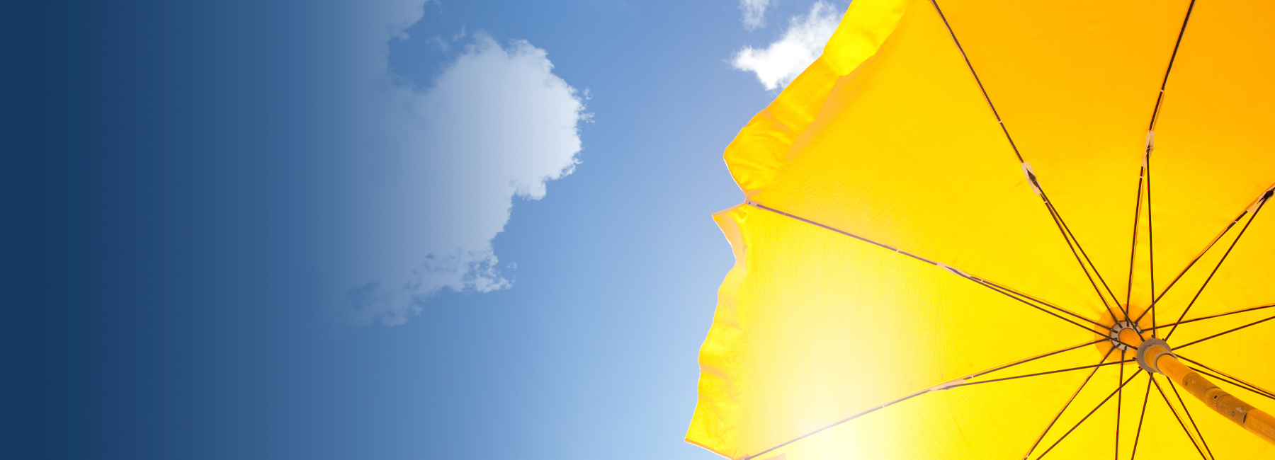 Yellow beach umbrella under sunny sky, Insurance BPS | DXC Technology