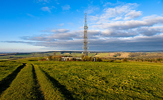 telecom tower in a field, Oracle | DXC Technology Customer Story